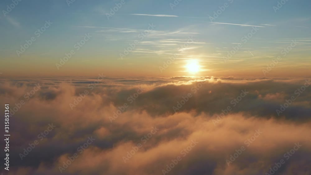 Flying above the clouds with a beautiful golden clouds and sunset and blue sky Flying above the clouds with a beautiful golden clouds and sunset and blue sky