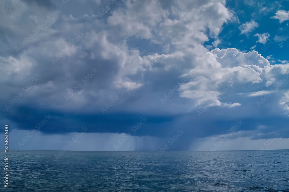 view of heavy raining in the sea with cloudy sky background, Ra Wi island, Tarutao National Marine Park, Stun, south of Thailand.