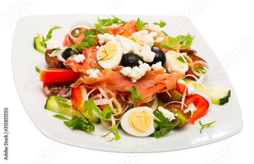 Salad with salmon, fresh  tomato, cucumber and  quail eggs at plate