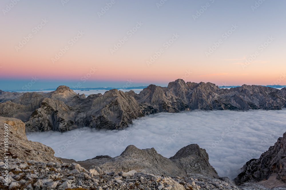 Spectacular morning mountain panorama with mists covering a valley.