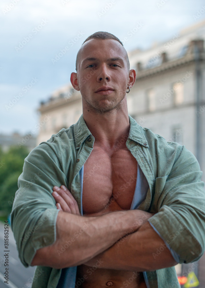 Handsome shirtless muscular young man outdoor on a balcony - obrazy, fototapety, plakaty 