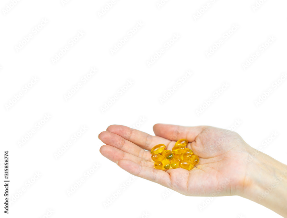 Hand holding Fish oil capsules on isolated white. Hand holding Fish oil capsules on isolated white.