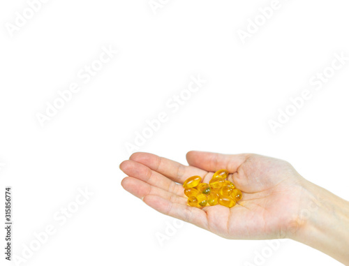 Hand holding Fish oil capsules on isolated white.