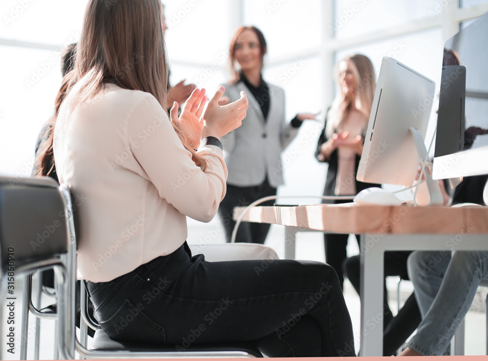 group of employees applauding during a business meeting group of employees applauding during a business meeting