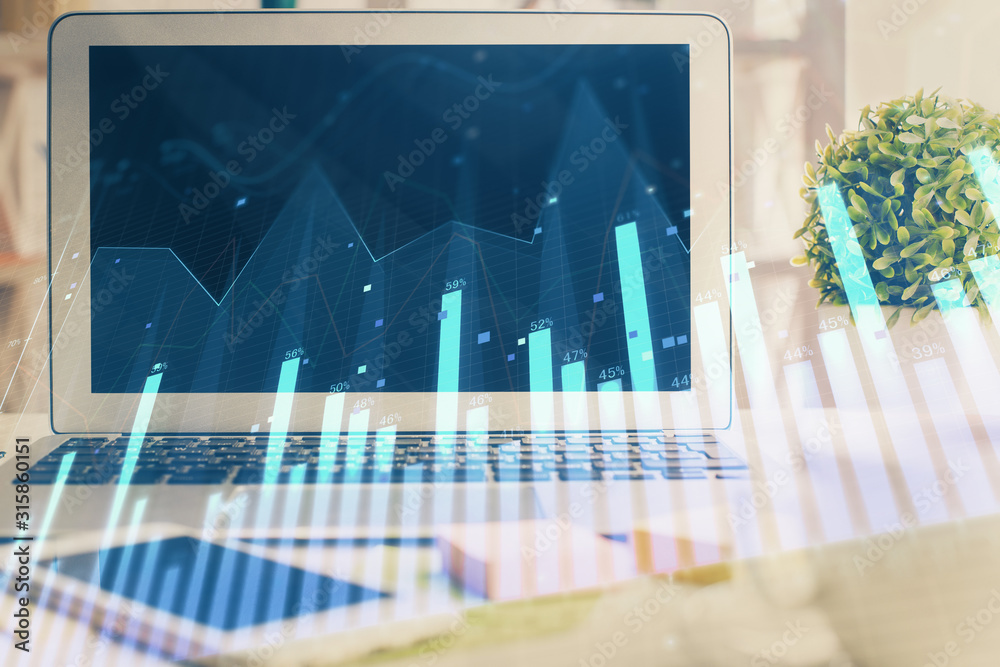 Forex market chart hologram and personal computer background. Double exposure. Concept of investment. Forex market chart hologram and personal computer background. Double exposure. Concept of investment.