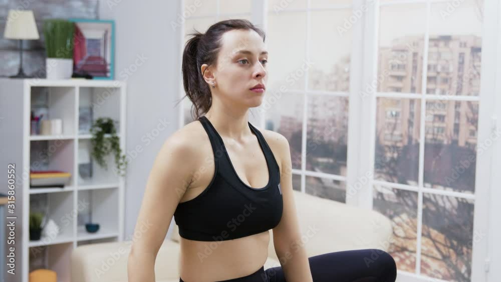 Young woman smiling while doing yoga Young woman smiling while doing yoga