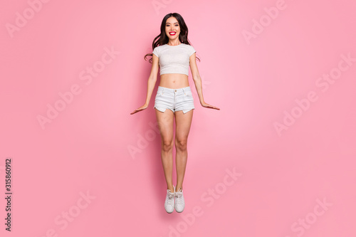 Full length body size view of her she nice attractive lovely charming slender thin cheerful funky cheery wavy-haired girl jumping up having fun isolated over pink pastel color background