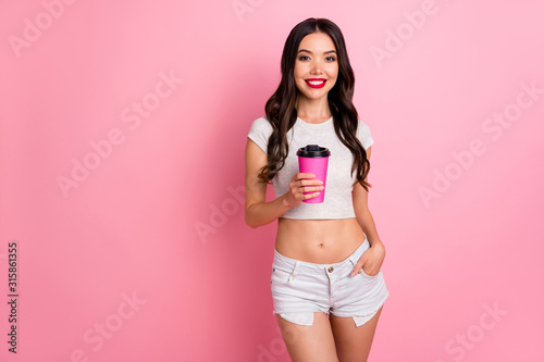 Portrait of her she nice attractive lovely charming gorgeous cheerful cheery wavy-haired girl drinking hot sweet latte isolated over pink pastel color background