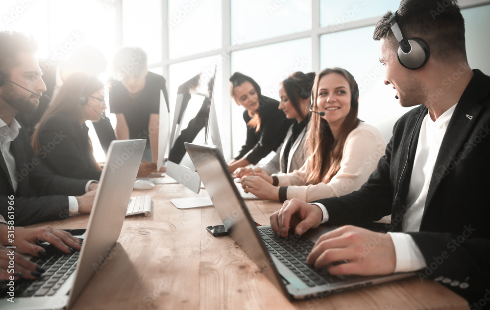 business center employees using computers in the workplace
