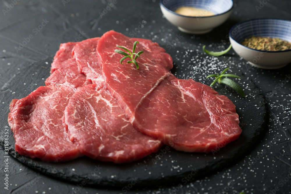 Fresh, thin beef steak with spices Fresh, thin beef steak with spices