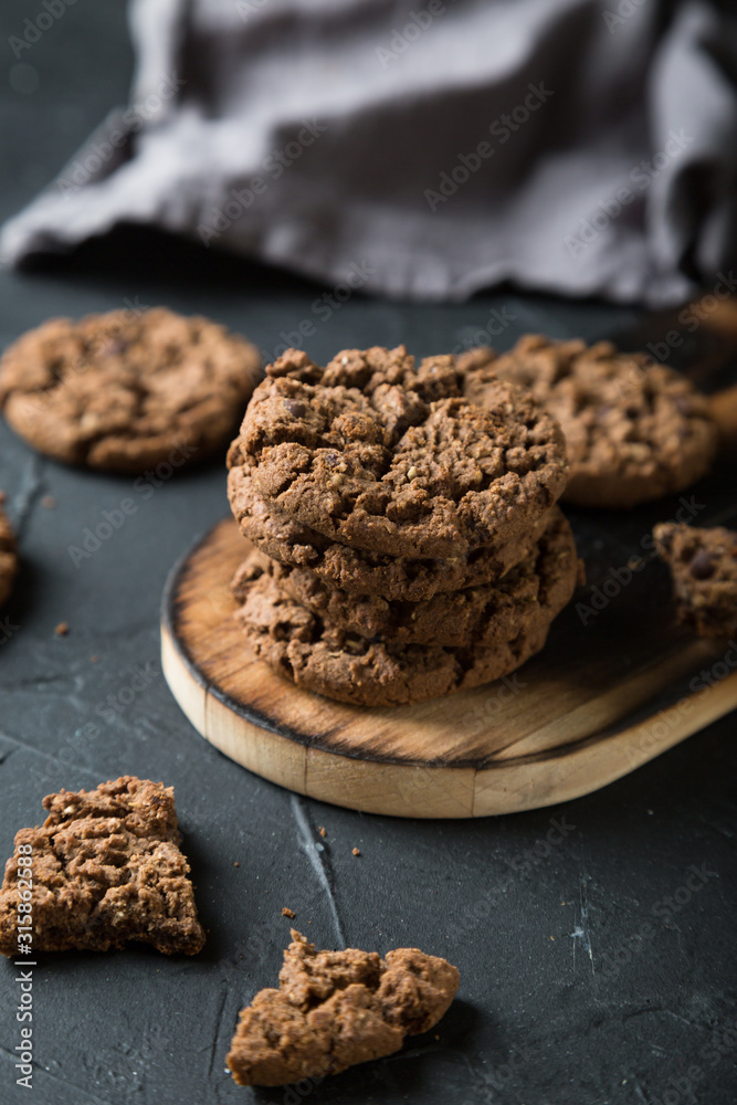 Fresh chocolate chip cookies on a dark background