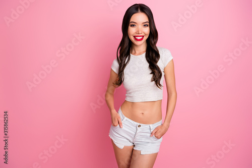 Portrait of her she nice-looking attractive pretty charming lovely slender fit cheerful cheery wavy-haired girl posing isolated over pink pastel color background