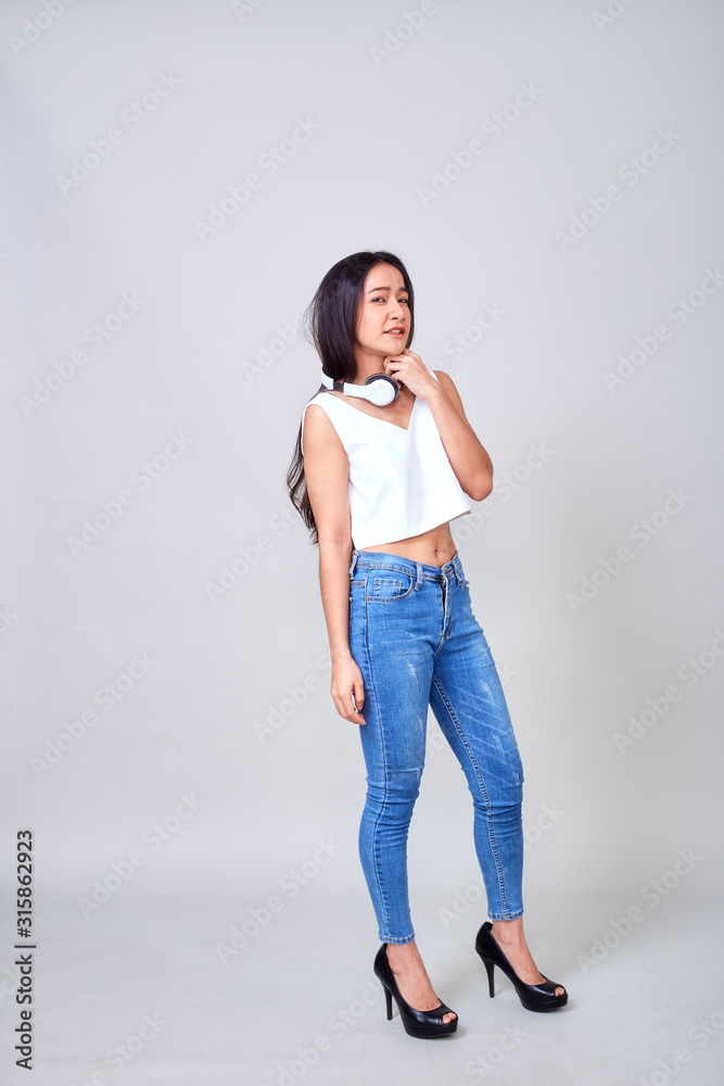 Asian woman wearing headphones dancing active Asian woman wearing headphones dancing active