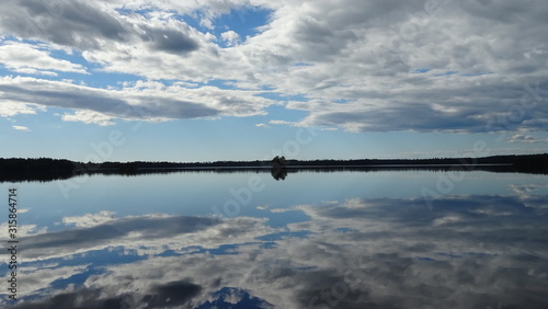 Mirroring clouds over a lake on a wind still afternoon 