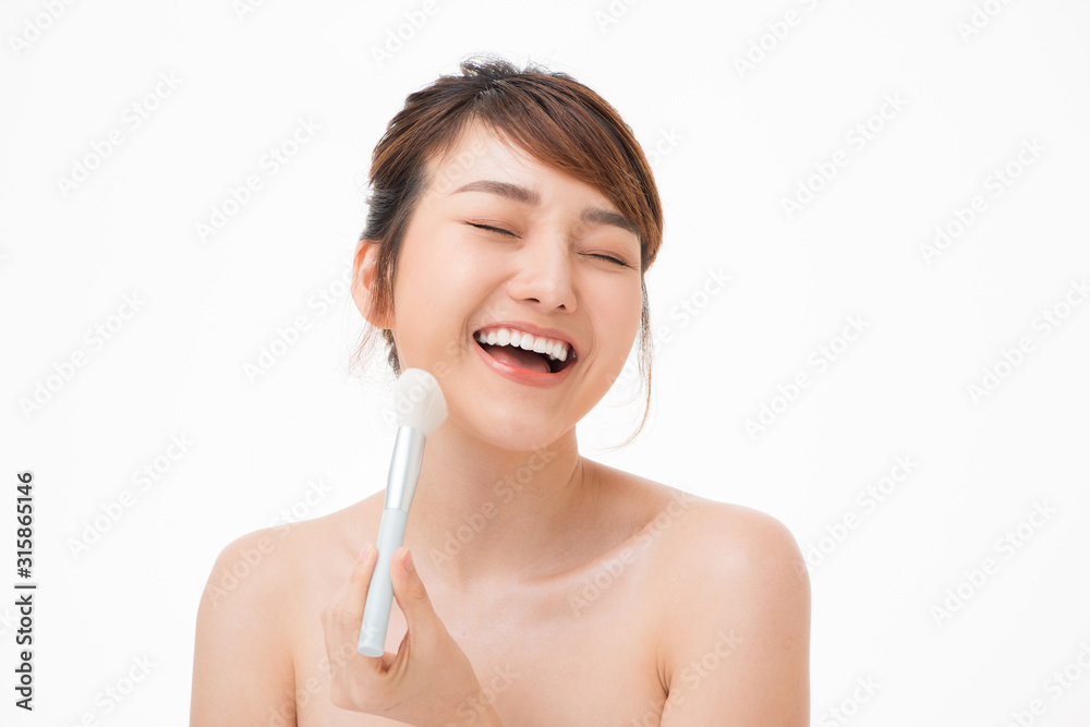 Beauty portrait young asian woman smile with brush cheek skin care and cosmetic concept. Beauty portrait young asian woman smile with brush cheek skin care and cosmetic concept.