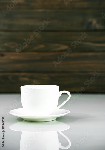 Coffee cup on table with wood background