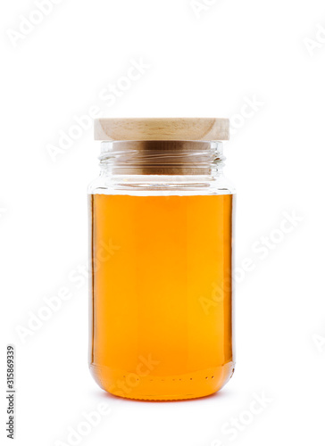 Honey jar with wooden cap on white background