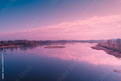 View from above of countryside and river et sunset. Nature landscape. Early spring