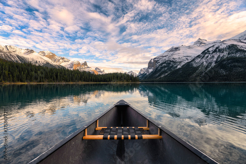 Canoeing on Maligne lake with canadian rockies reflection in Spirit Island at Jasper national park