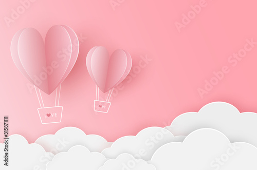 Two paper heart balloon flying on the pink sky