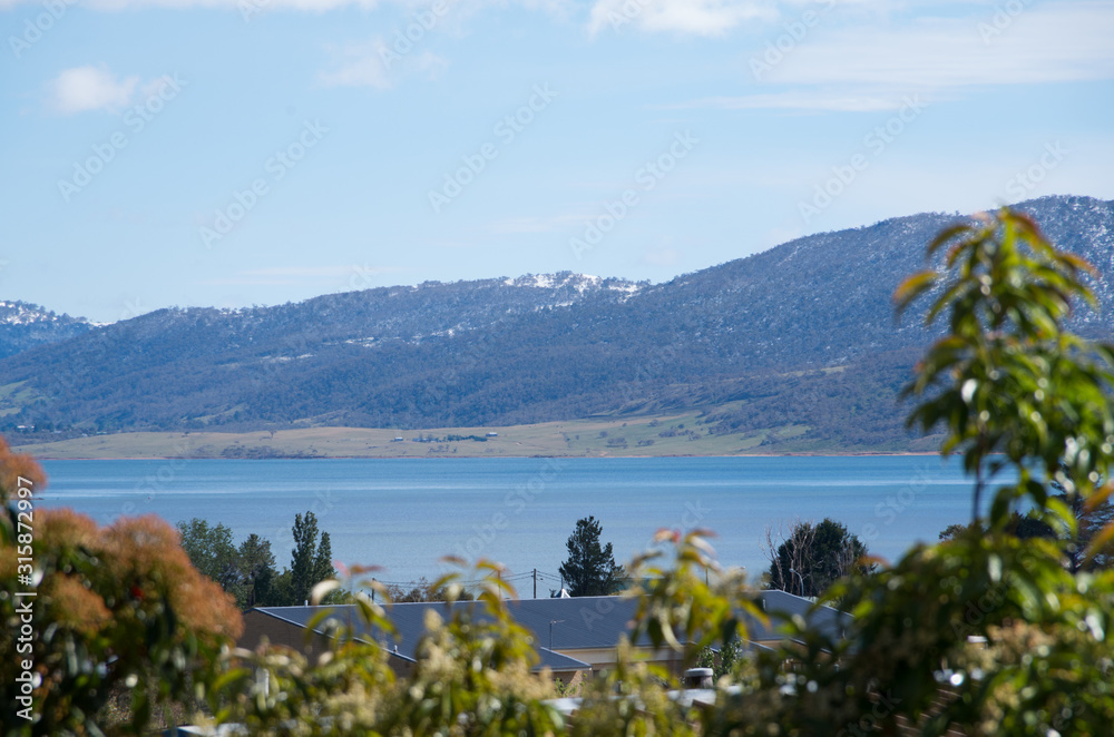 Lake Jindabyne, Jindabyne townshipand surrounding mountains covered in a dusting of snow