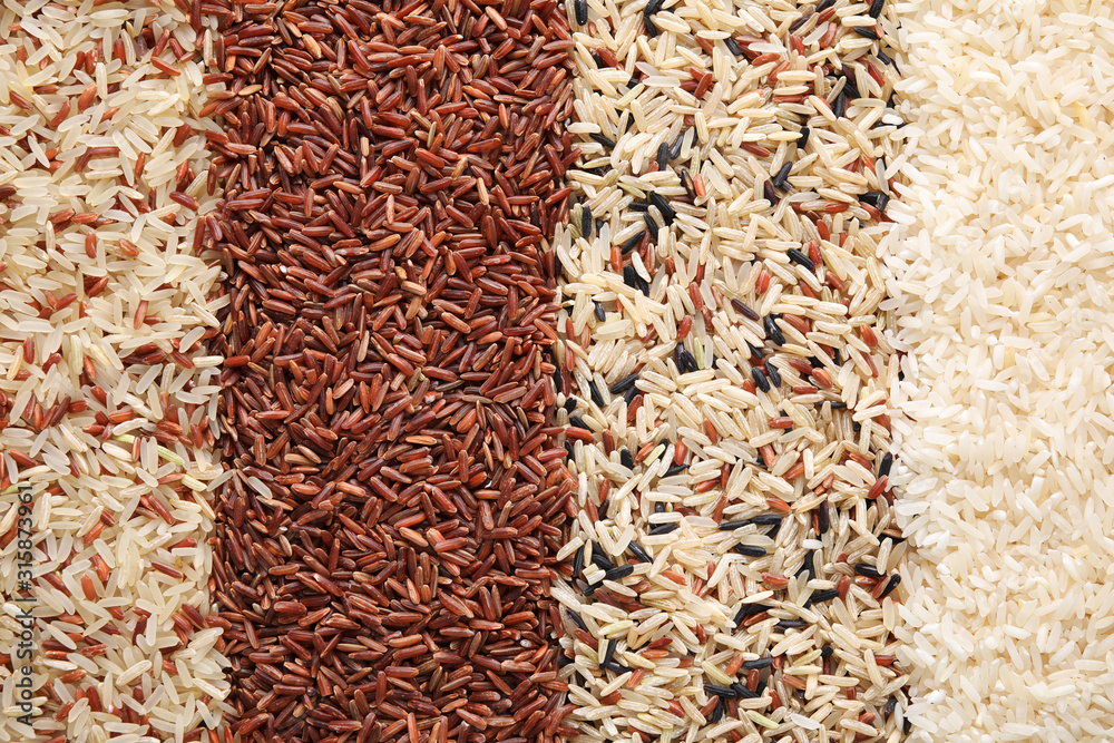 Different types of rice as background, top view