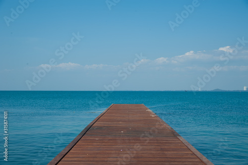 Wood bridge on the sea and blue sky. © Petit_G