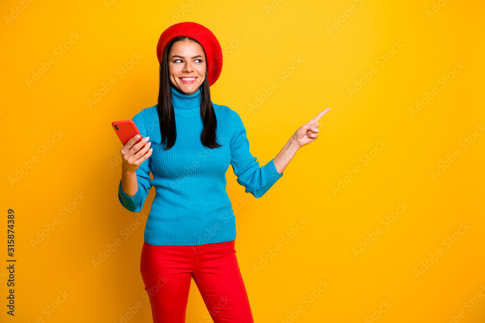 Portrait of nice attractive lovely cheerful cheery girl using cell showing copy space ad advert store boutique shopping online isolated over bright vivid shine vibrant yellow color background Portrait of nice attractive lovely cheerful cheery girl using cell showing copy space ad advert store boutique shopping online isolated over bright vivid shine vibrant yellow color background