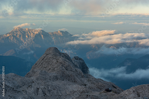 Spectacular mountain view with evening clouds rolling over peaks and ridges.