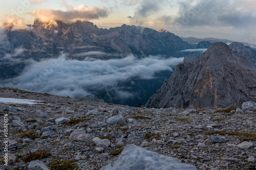 Spectacular mountain view with evening clouds rolling over peaks and ridges.