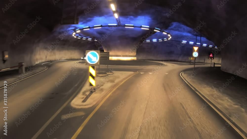 Butunnel is a three-armed tunnel in Norway. Inside the tunnel is a roundabout. Car rides through the tunnel point-of-view driving