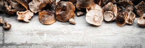 Banner, Lentinula edodes on wooden table with copyspace, shiitake mushrooms photo