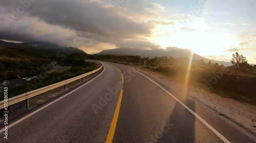 Driving a Car on a Road in Norway at dawn