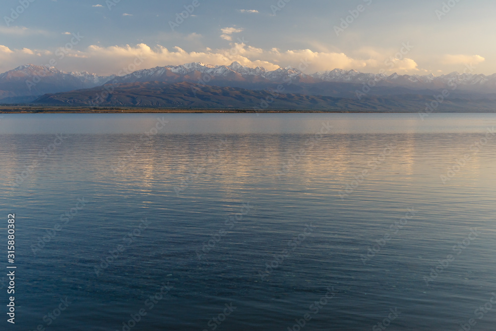 South shore of Issyk-kul lake in Kyrgyzstan, lake on a background of snow-capped mountains
