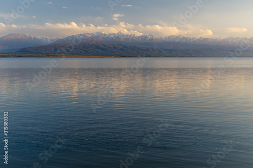 South shore of Issyk-kul lake in Kyrgyzstan, lake on a background of snow-capped mountains