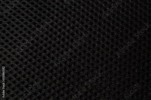 texture of black mesh fabric used in the upholstery of chairs and bags photo