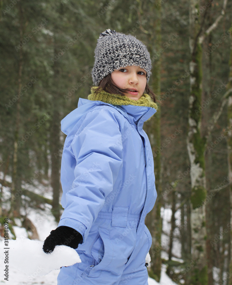 young girl showing snow for winter and nature fun symbols