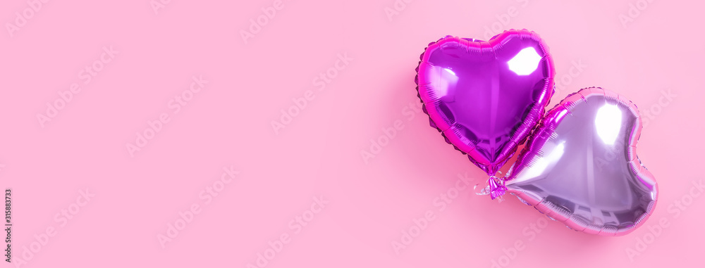 Valentine's Day minimal design concept - Beautiful real heart shape foil balloon isolated on pale pink background, top view, flat lay, overhead above photography. Valentine's Day minimal design concept - Beautiful real heart shape foil balloon isolated on pale pink background, top view, flat lay, overhead above photography.