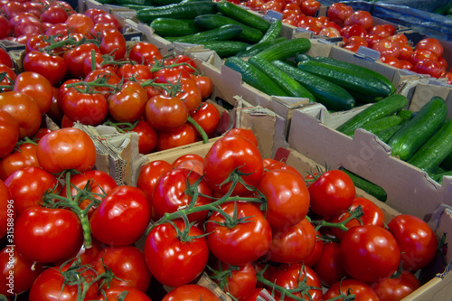 sale of tomatoes and cucumbers in the vegetable department photo