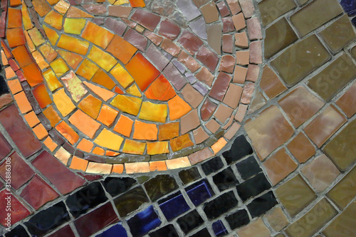 Mosaic pattern of multicolored tiles on the wall