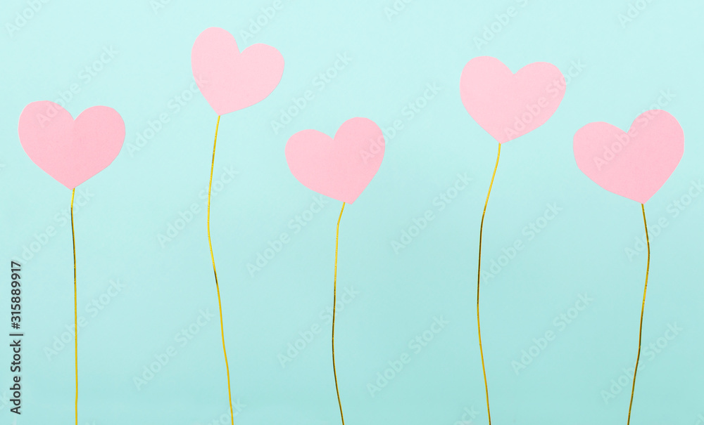 Lot of paper pink hearts and colored golden wire against blue background.Concept of valentine`s day and gifts, cards - obrazy, fototapety, plakaty 