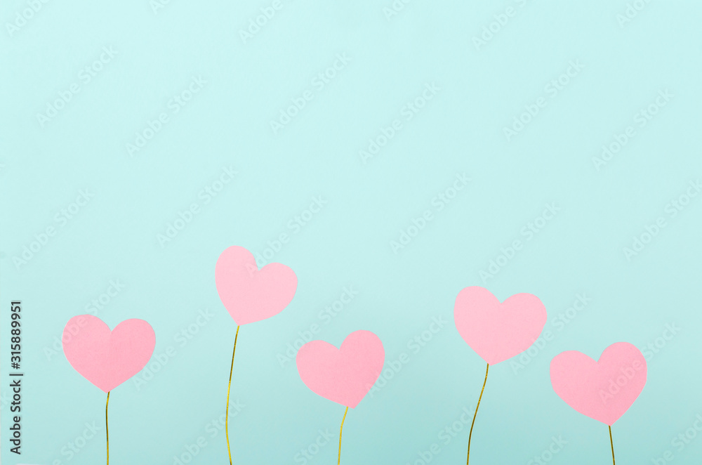 Cute little pink hearts against blue background.Empty space for text.Concept of presents for valentine`s day