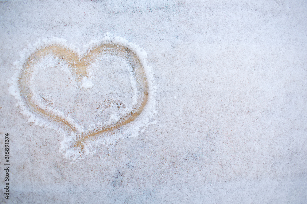 The shape of heart on the fresh snow with copy space.