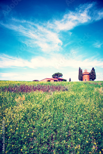 Obraz na płótnie Magic nice landscape with rape flowers and chapel of Madonna di Vitaleta in background on a sunny day in San Quirico d'Orcia (Val d'Orcia) in Tuscany, Italy. Excellent tourist places. w salonie