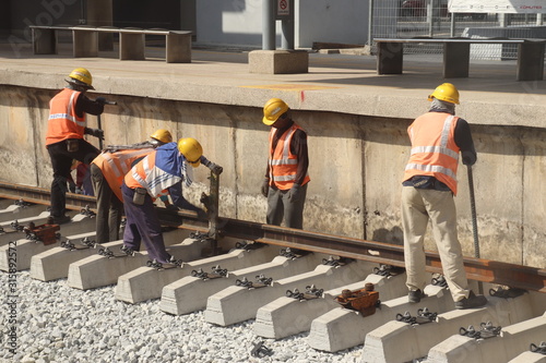 Workers installing new railway for train