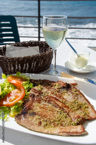 Tasty seafood, grilled tuna fish steaks served on outdoor terrace on Puerto Naos, La Palma, Canary islands, Spain photo