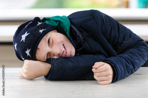 Portrait of a teenage boy in a park, autumn, october, emotions, happy, laughing.