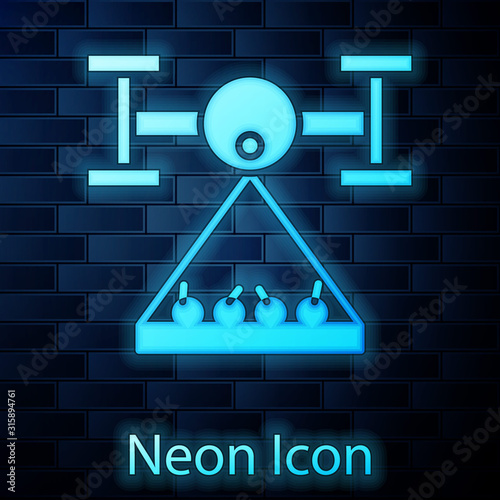 Glowing neon Smart farm with drone control collects harvest icon isolated on brick wall background. Innovation technology for agricultural company. Vector Illustration
