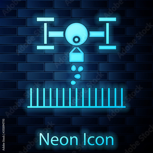 Glowing neon Smart farm with drone control for seed planting icon isolated on brick wall background. Innovation technology for agricultural company. Vector Illustration