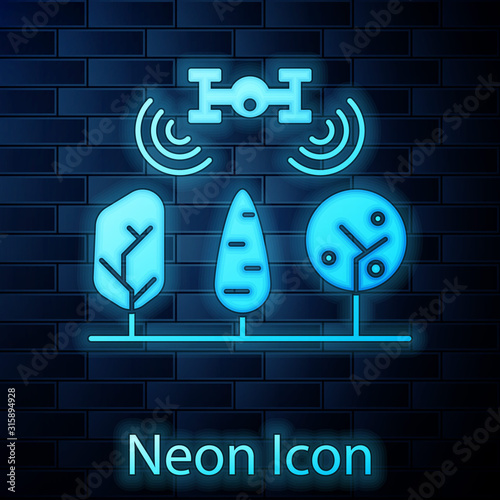 Glowing neon Smart farm with drone control and tree icon isolated on brick wall background. Innovation technology for agricultural company. Vector Illustration